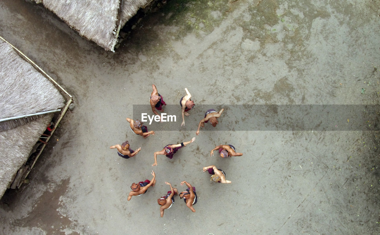 Directly above shot of people performing gegerok tandak dance on street