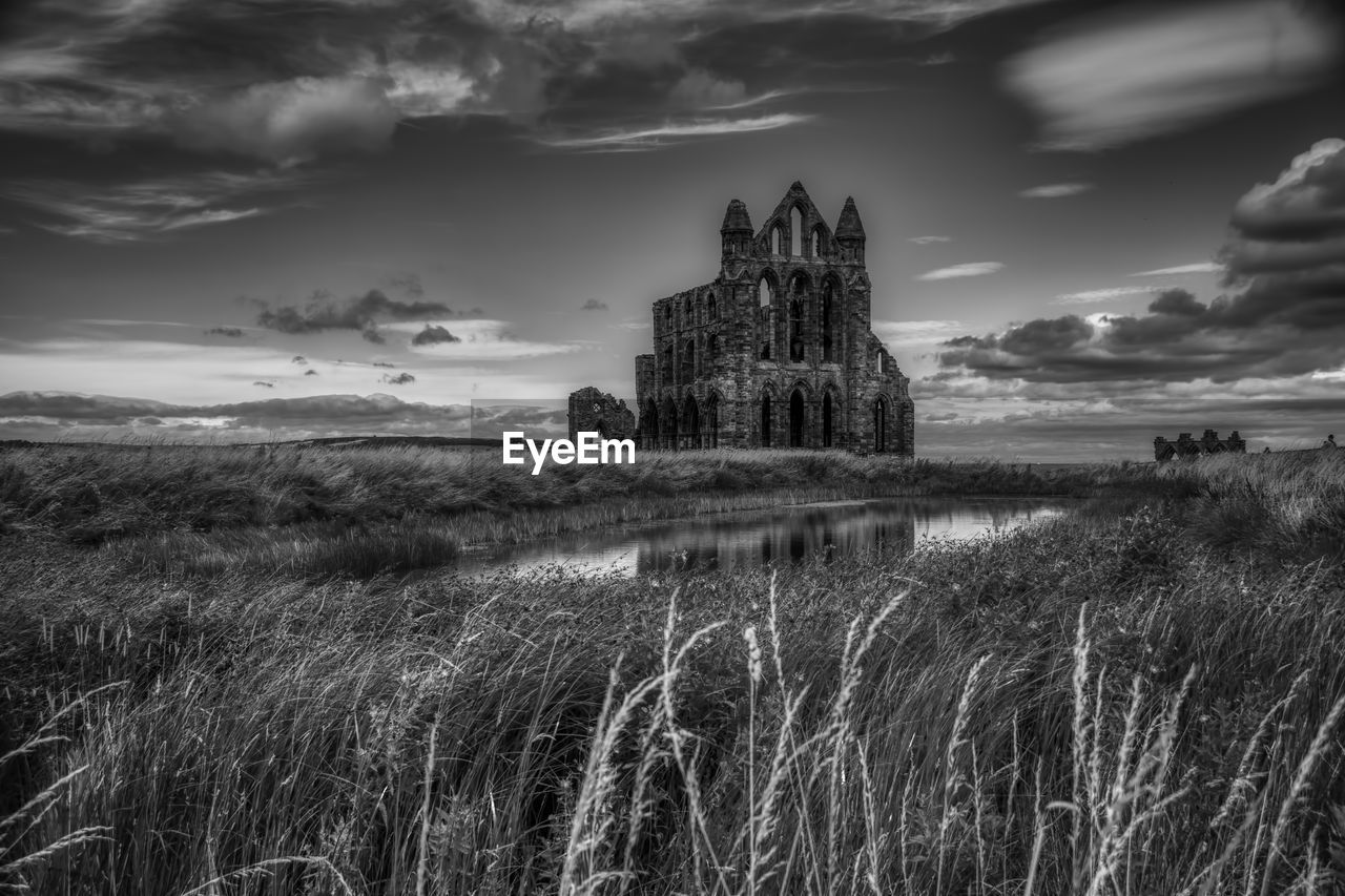 OLD RUIN OF BUILDING ON FIELD