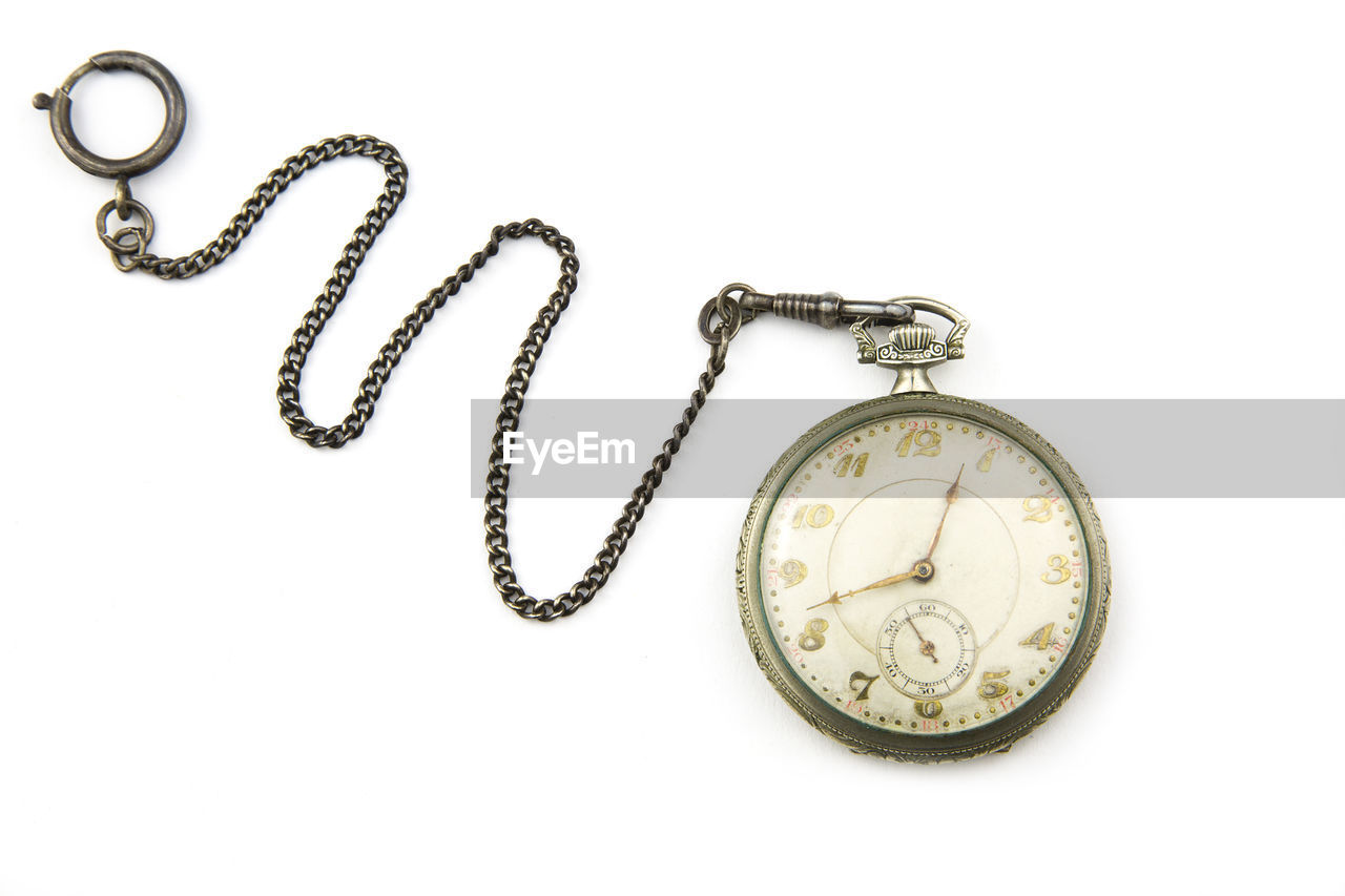 Close-up of old pocket watch against white background