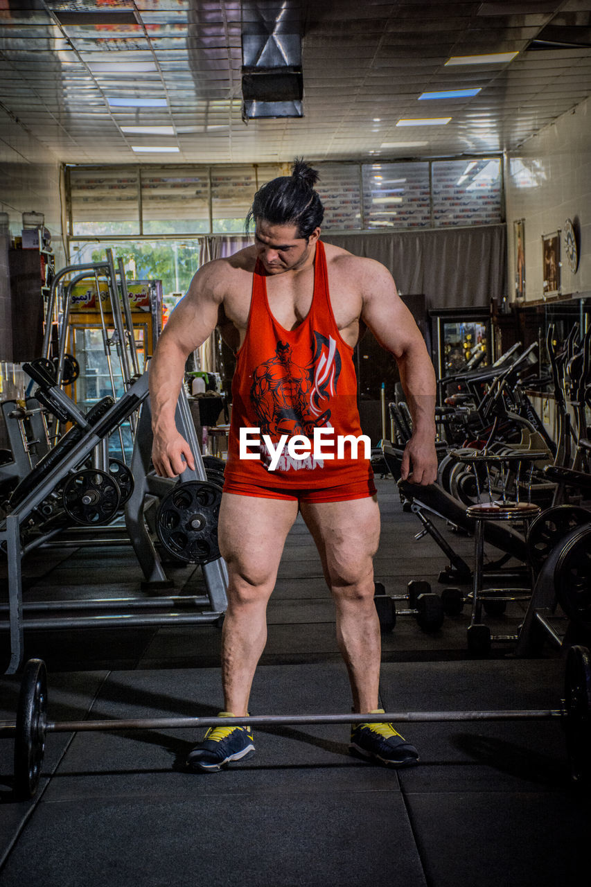 Bodybuilder standing in gym