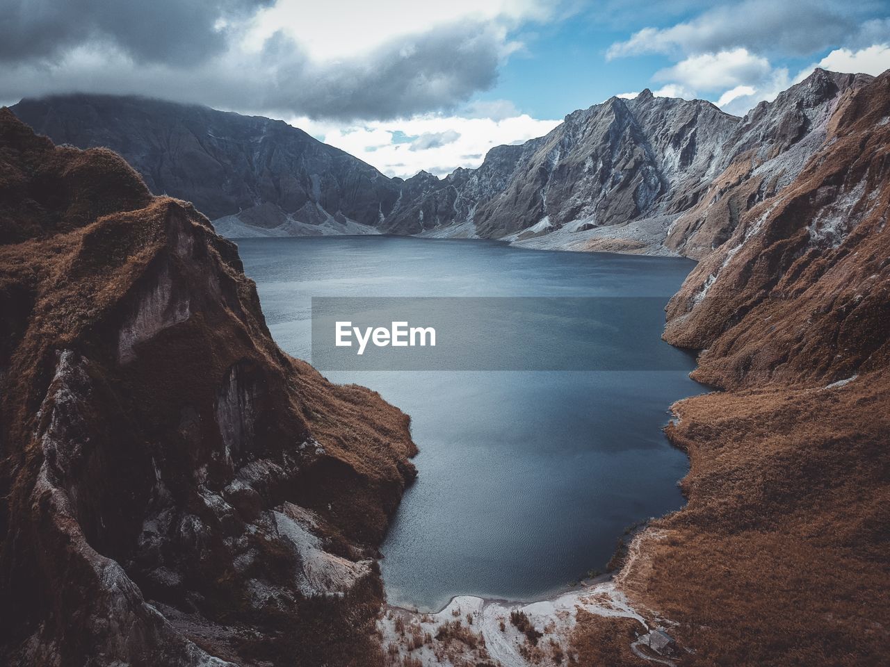 Scenic view of sea and mountains against sky