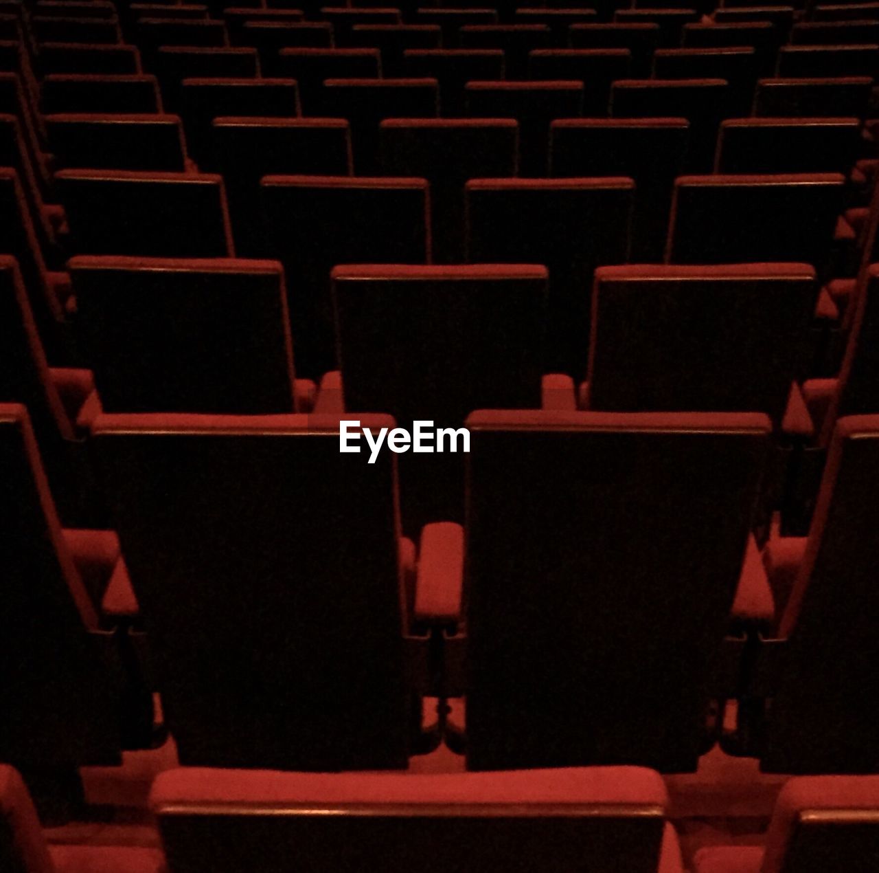 Full frame shot of empty red seats at movie theater