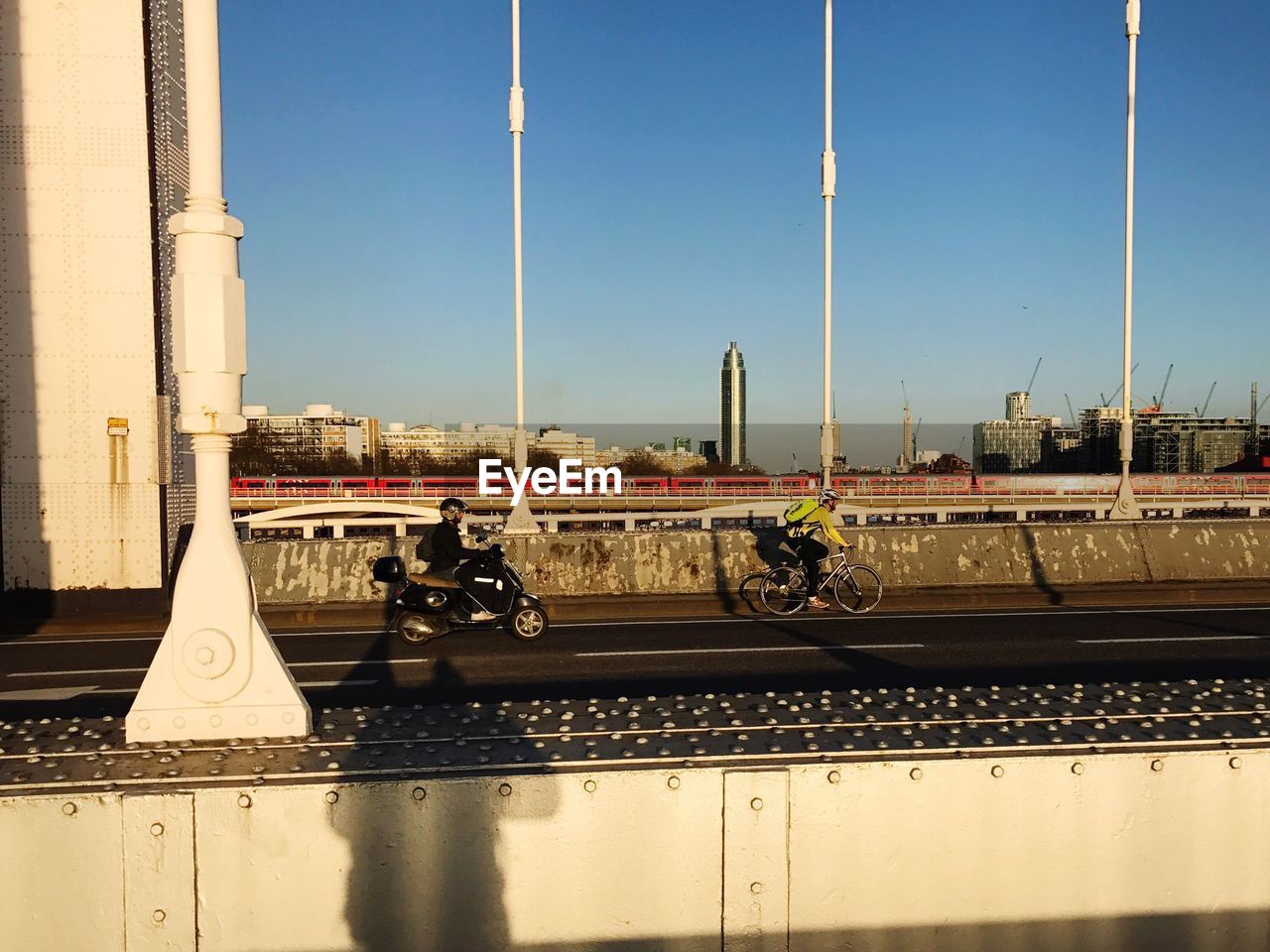 Cars on bridge against clear sky