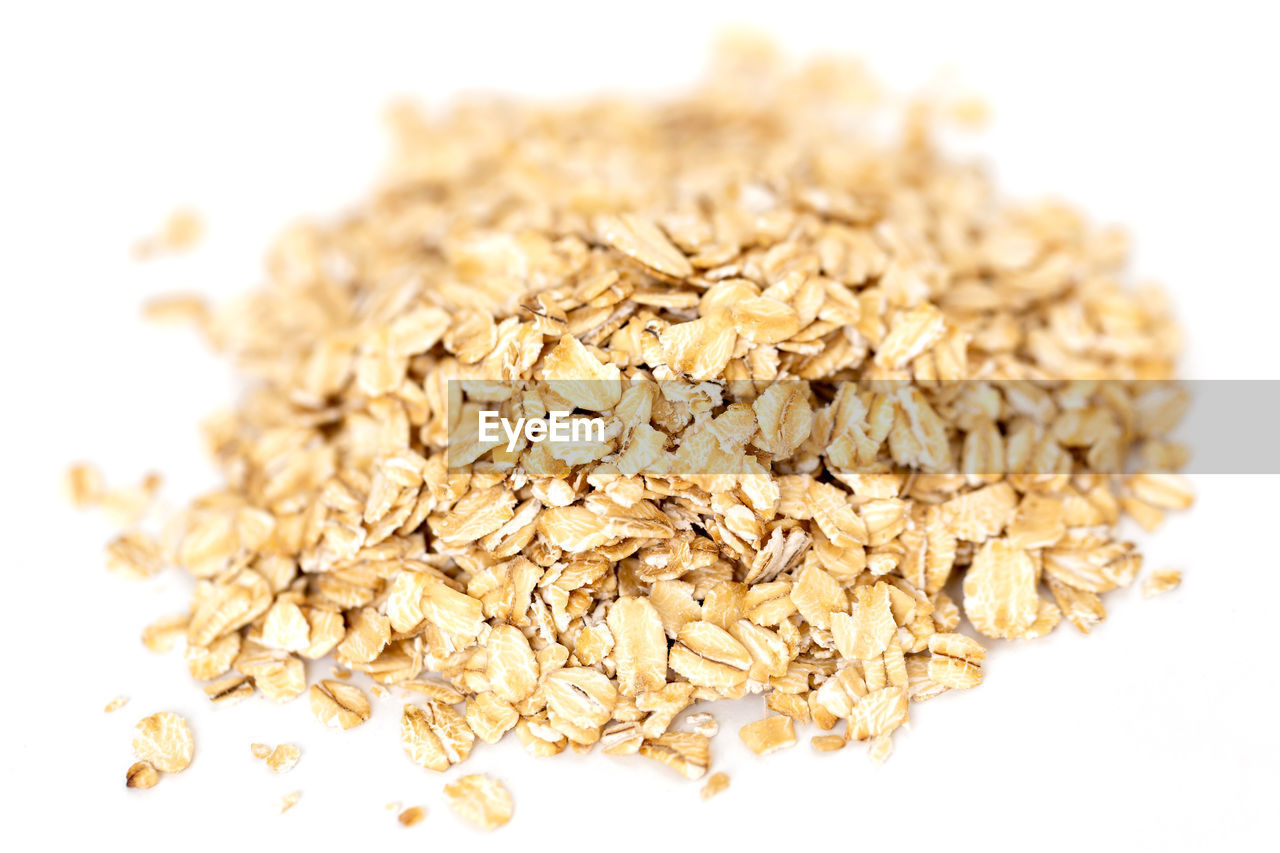 Heap of whole organic oats isolated on white background