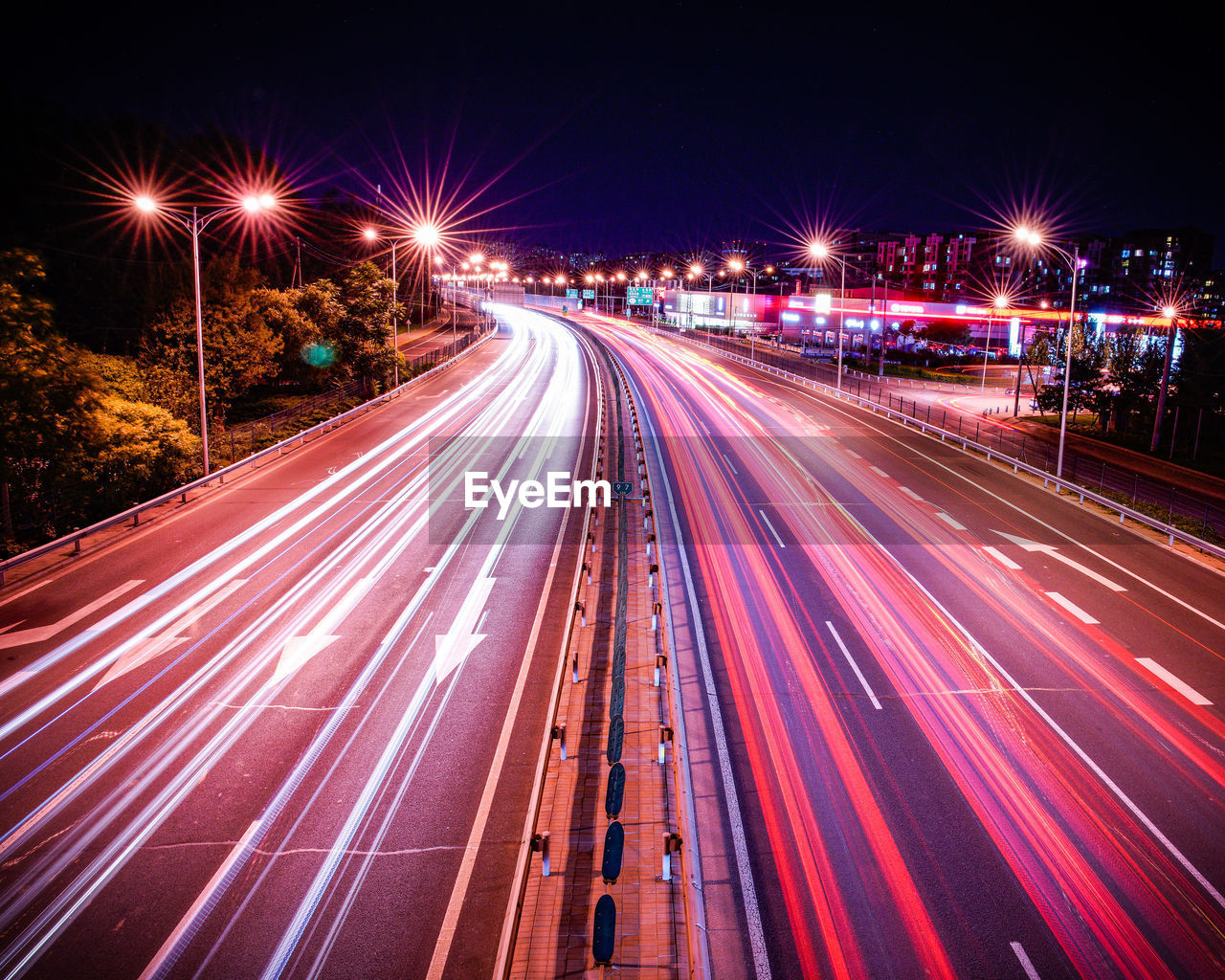 High angle view of light trails on highway at night