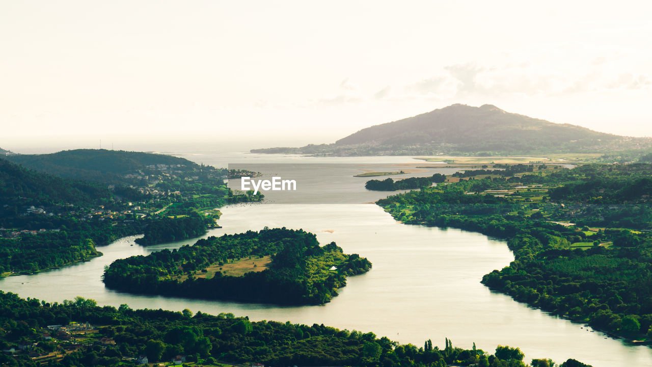 Scenic view of sea, river and mountains against clear sky