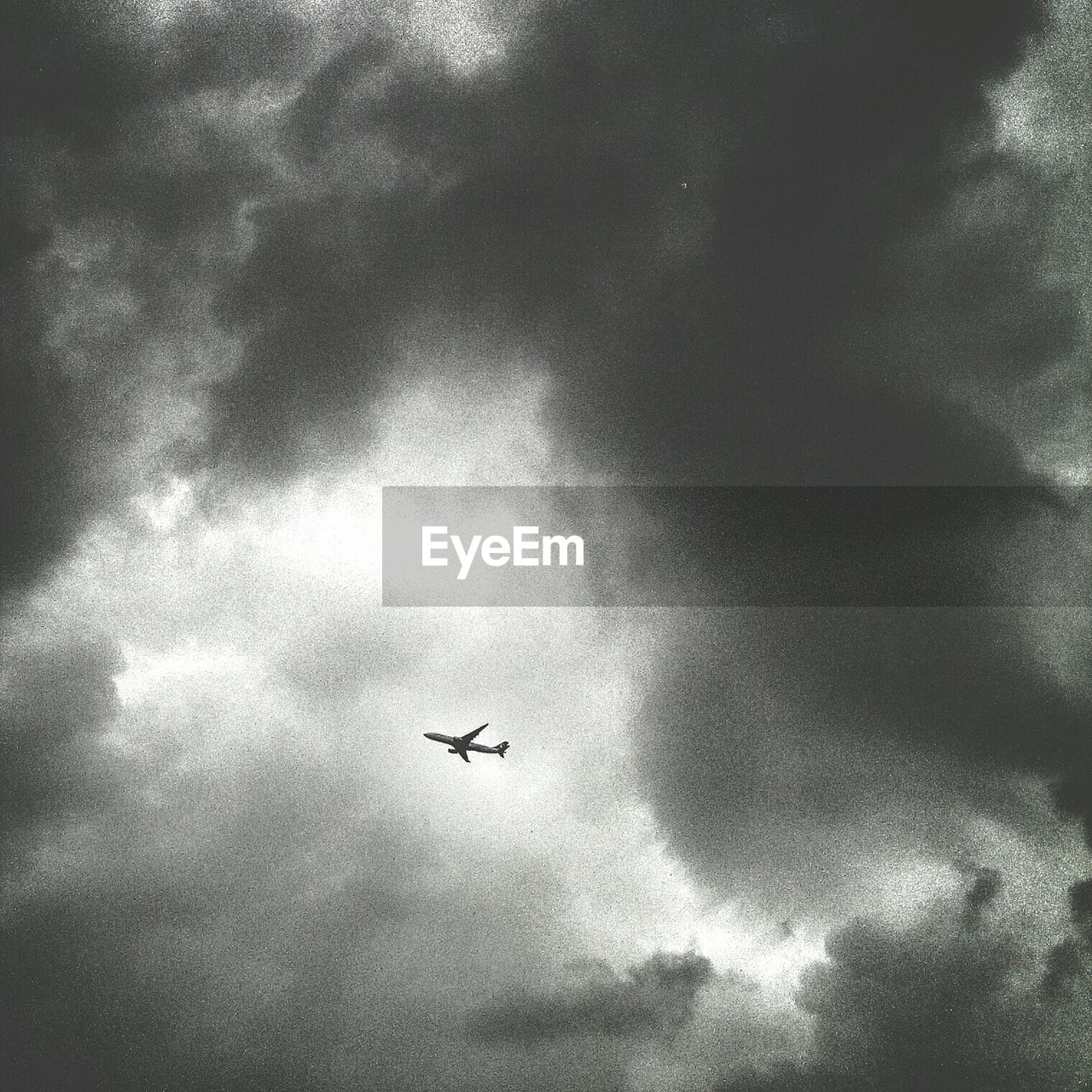 Airplane in cloudy sky