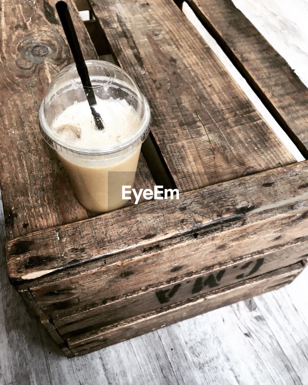 Close-up of cold coffee in disposable glass on table