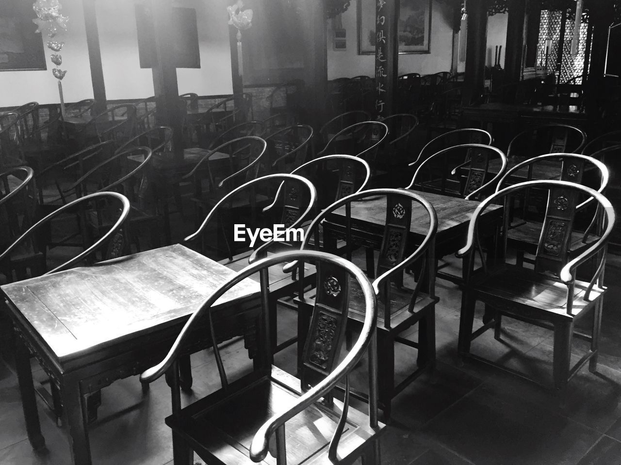 Empty chairs and tables arranged in seminar room