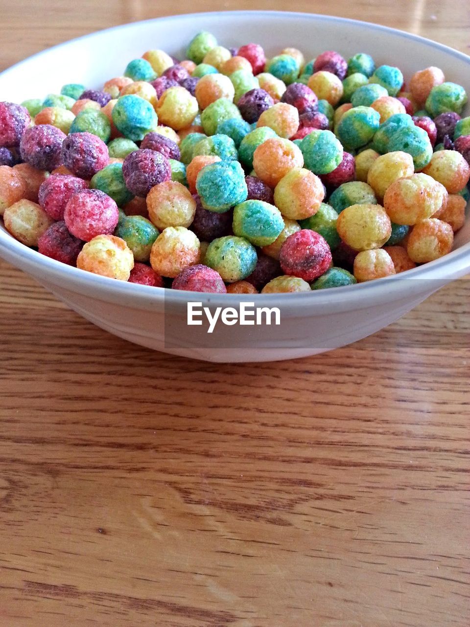High angle view of colorful cereals in bowl on table