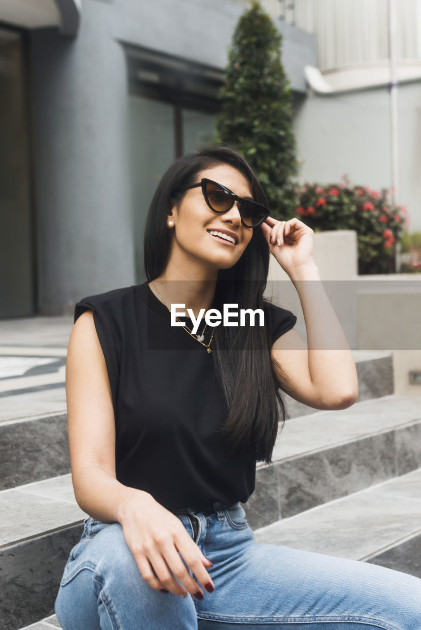 Beautiful hispanic woman with jeans t-shirt smiling