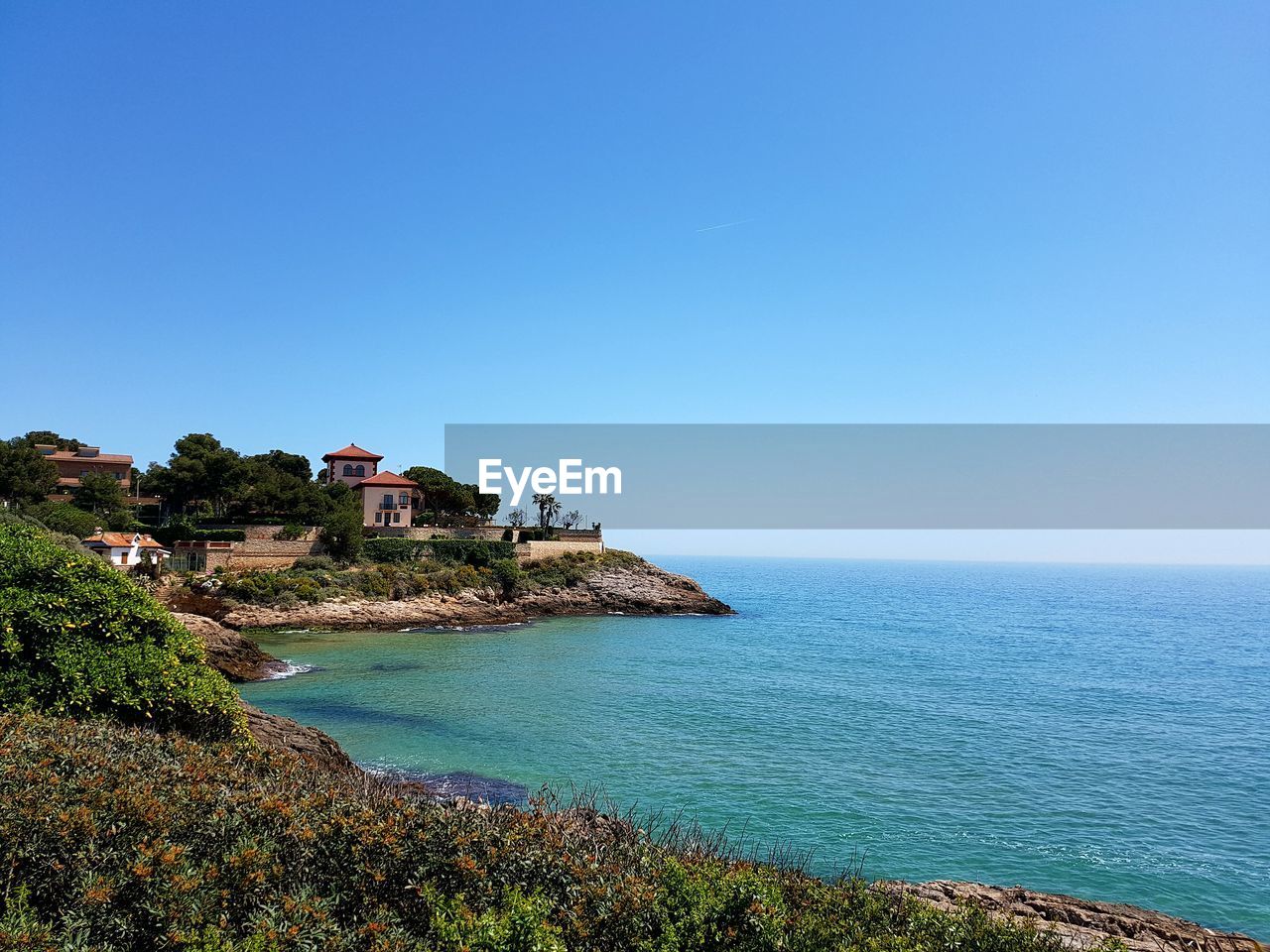 Scenic view of sea against clear blue sky