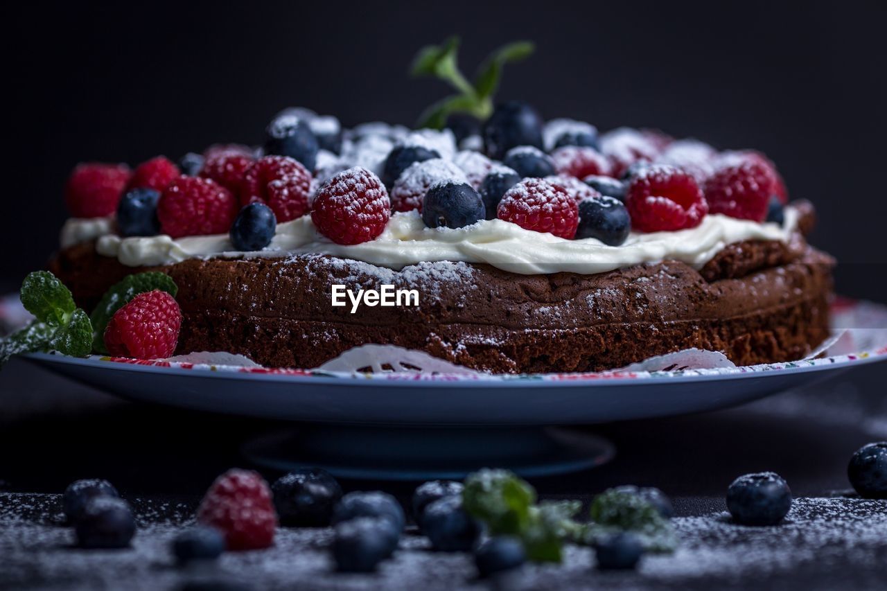 Close-up of berry fruits on sweet food in plate