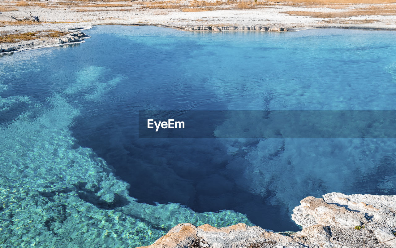 Close-up of sapphire pool with sky in background at yellowstone national park