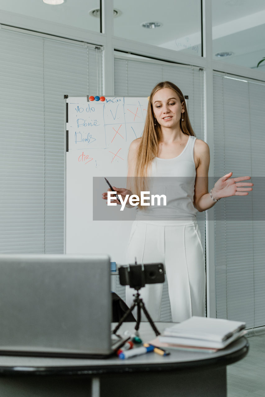 Young woman giving presentation in office