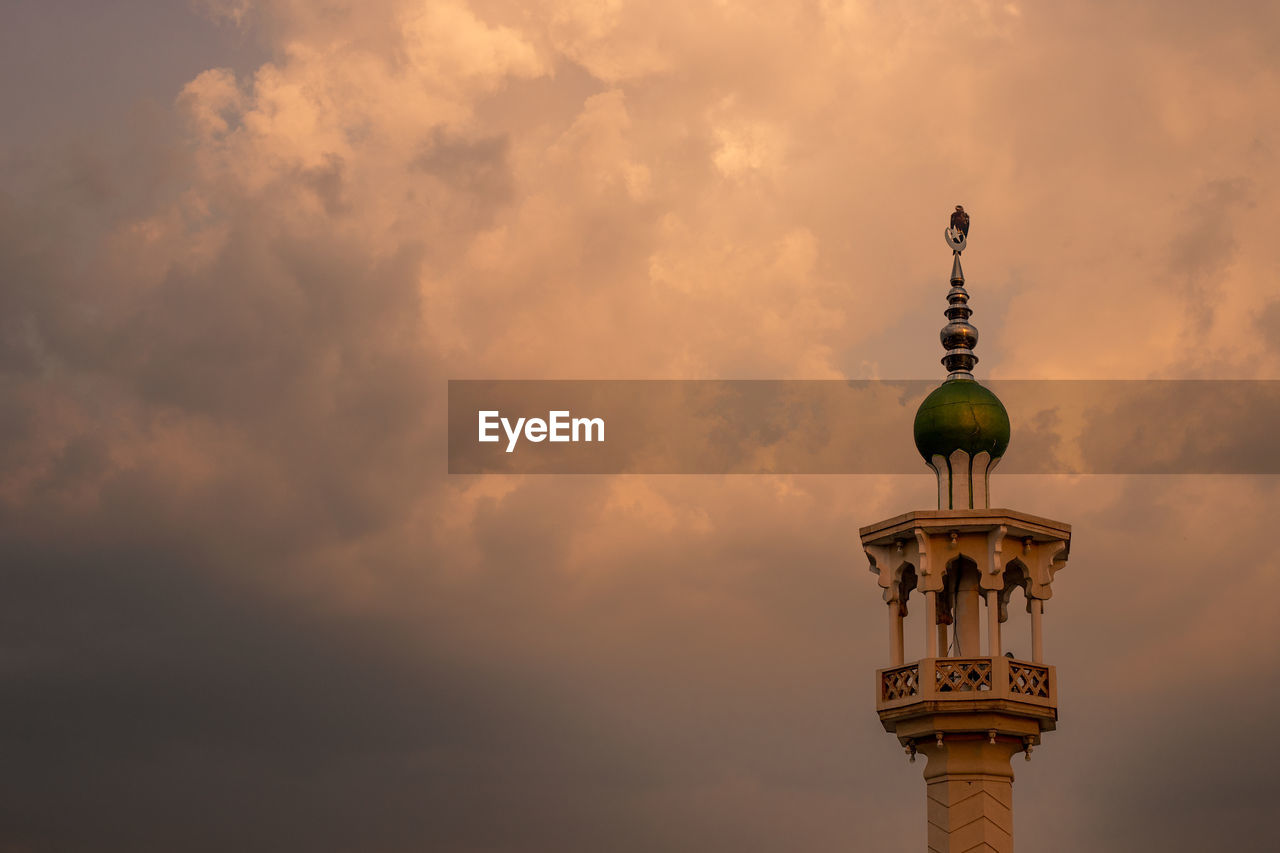 Low angle view of tower against sky during sunset