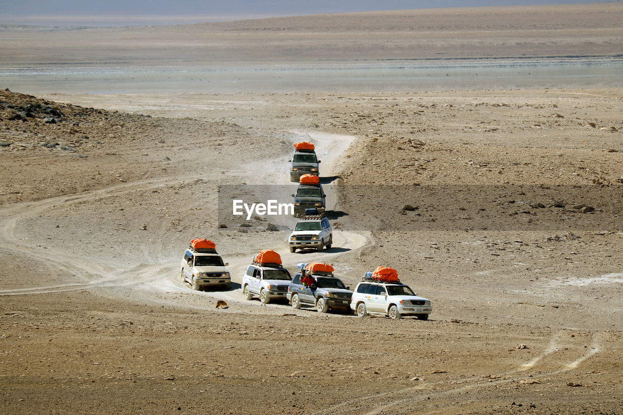 Group of camper vans running on the desert road, eduardo avaroa andean fauna, potosi, bolivia