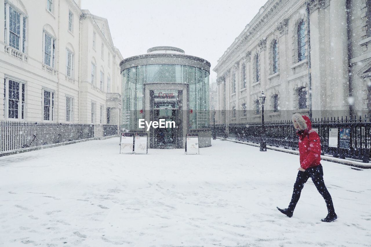 FULL LENGTH OF MAN WALKING IN SNOW