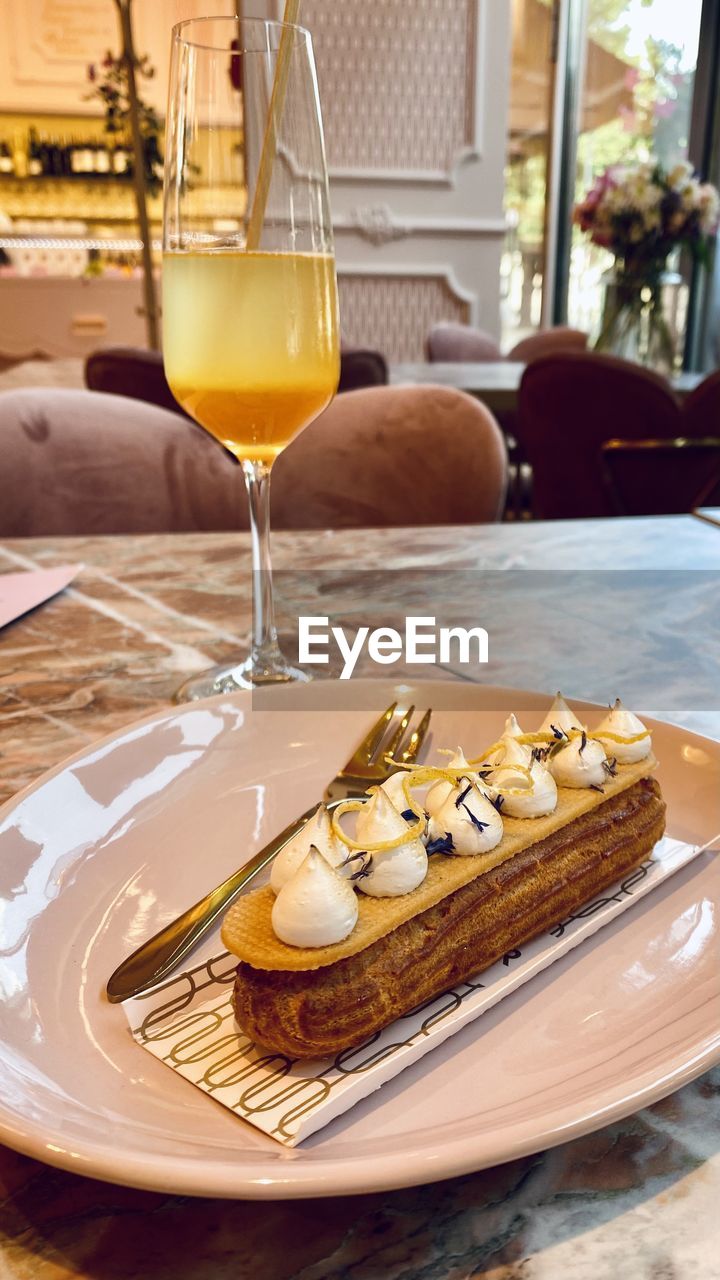 High angle view of decadent pastry and drink in plate on table