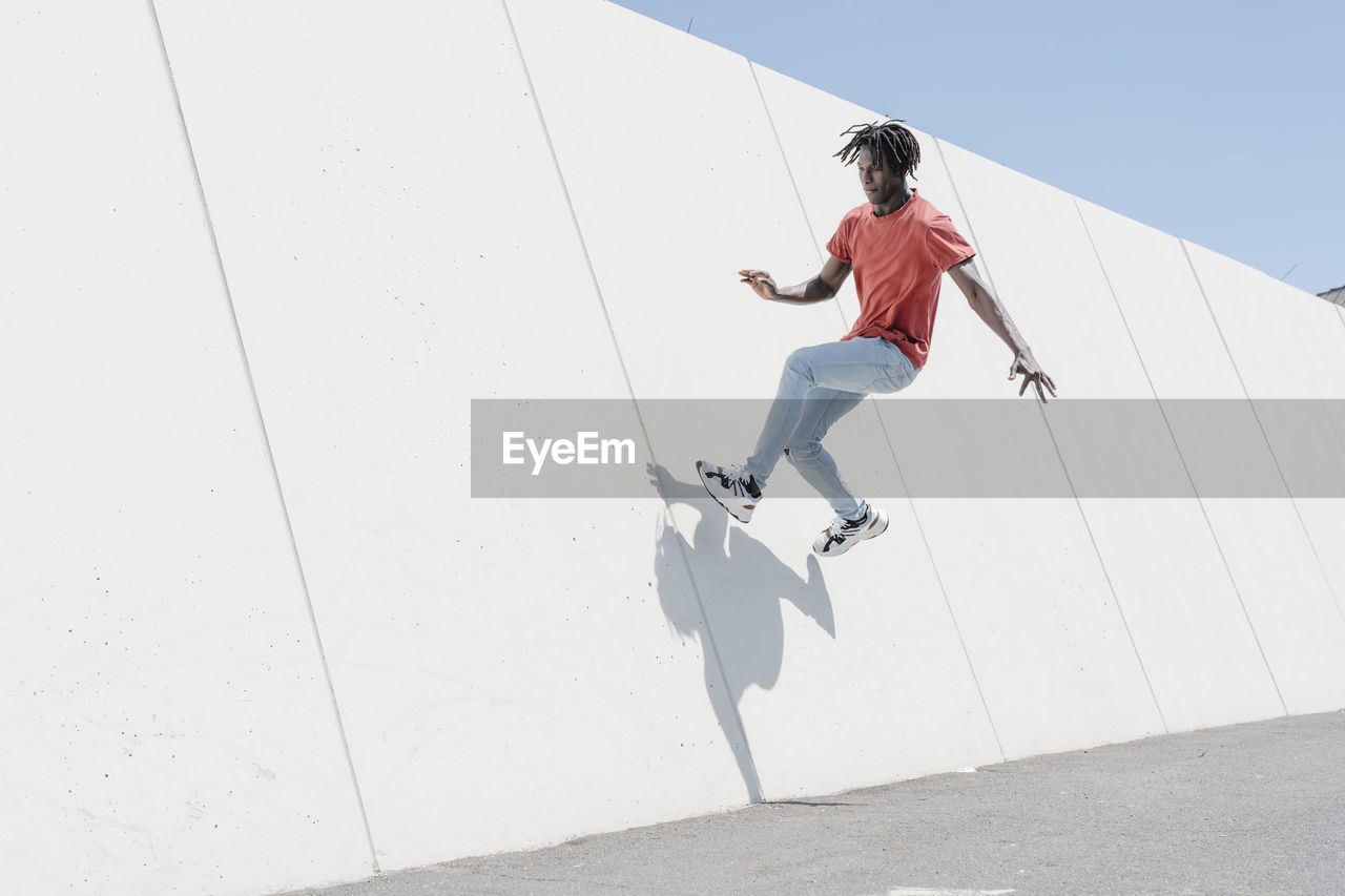 Energetic man jumping on ramp