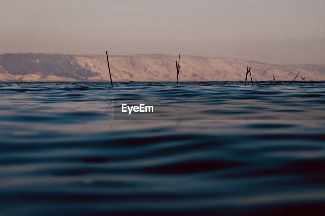 The calm waters of lake tiberias in israel at sunset. photo taken from the beach