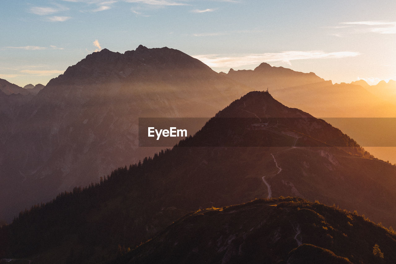 Scenic view of mountains against cloudy sky