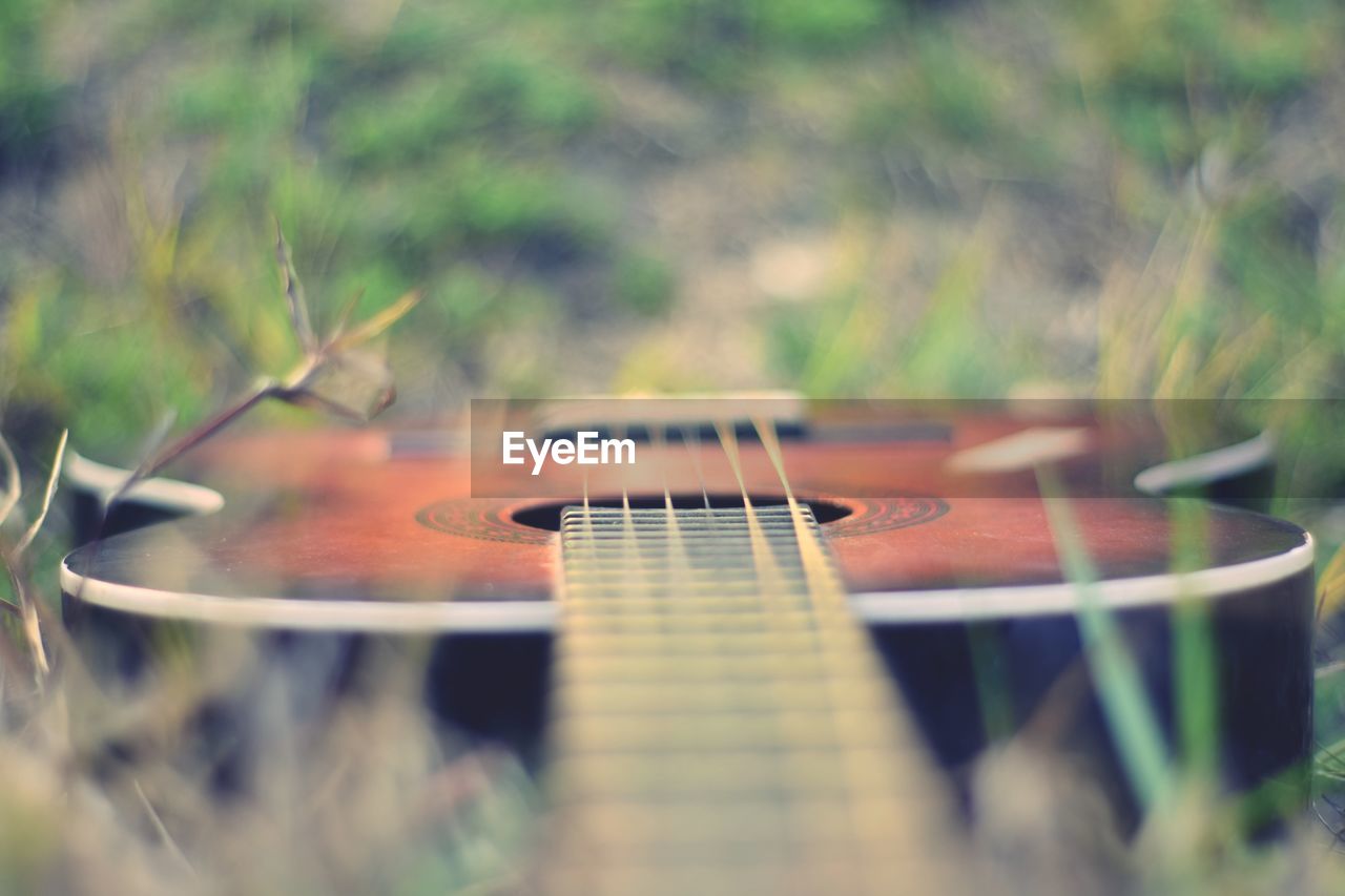 Close-up of guitar on field