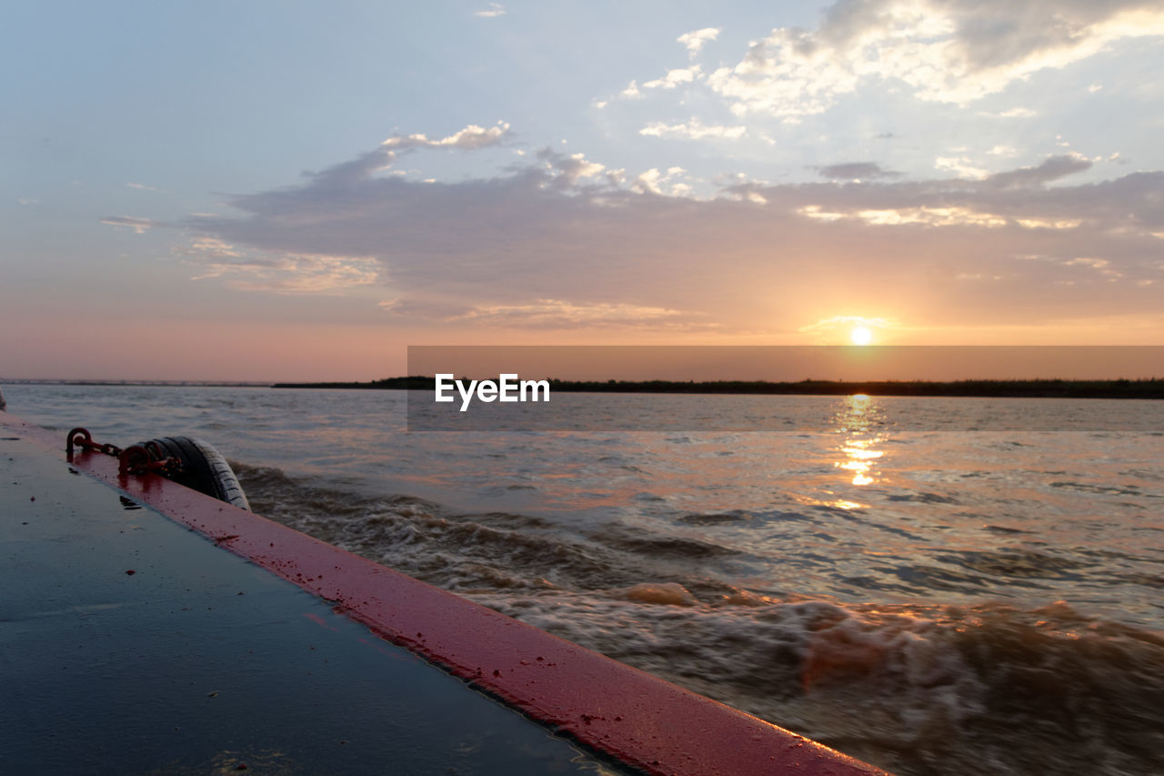 scenic view of beach against sky during sunset