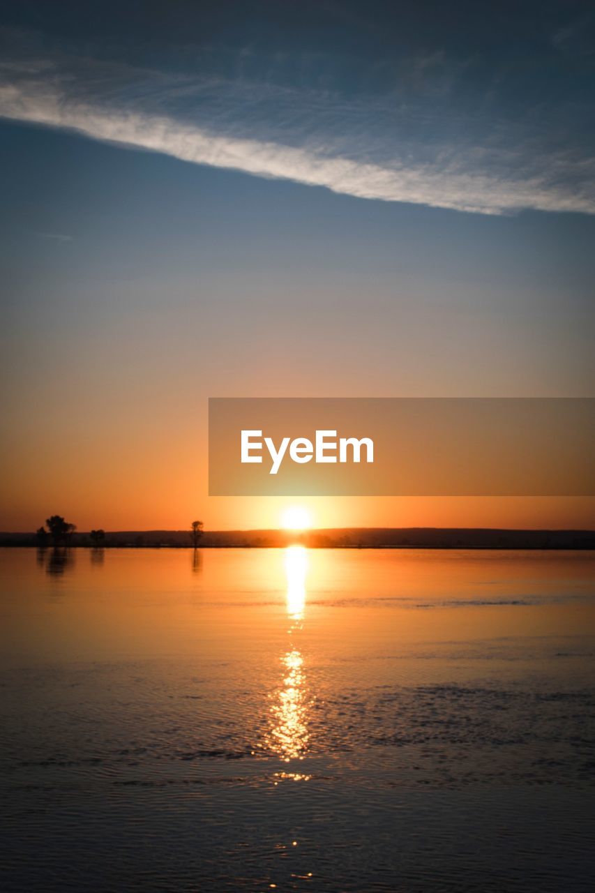 SCENIC VIEW OF SEA AGAINST ORANGE SKY DURING SUNSET