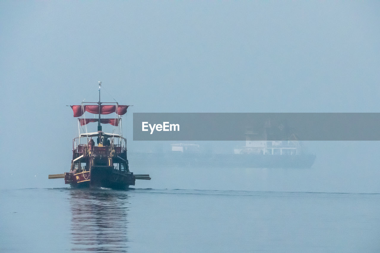 water, vehicle, sea, transportation, fog, nautical vessel, sky, nature, ocean, architecture, tower, no people, built structure, ship, day, mode of transportation, outdoors, copy space, industry, waterfront, watercraft, business, ferry, tranquility, building exterior, boat