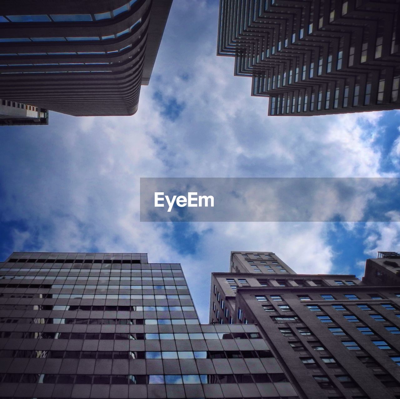 Low angle view of buildings against cloudy sky