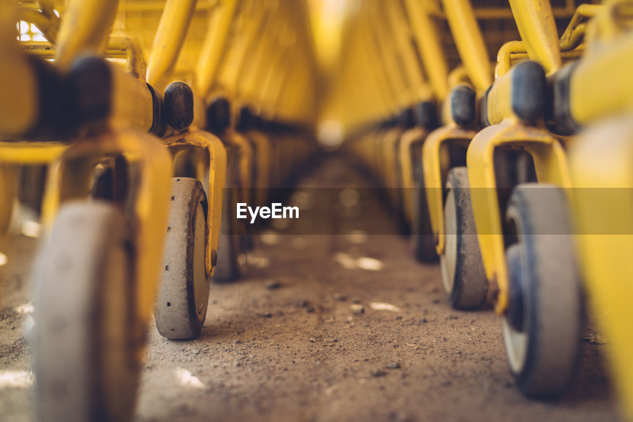 Yellow shopping carts on footpath