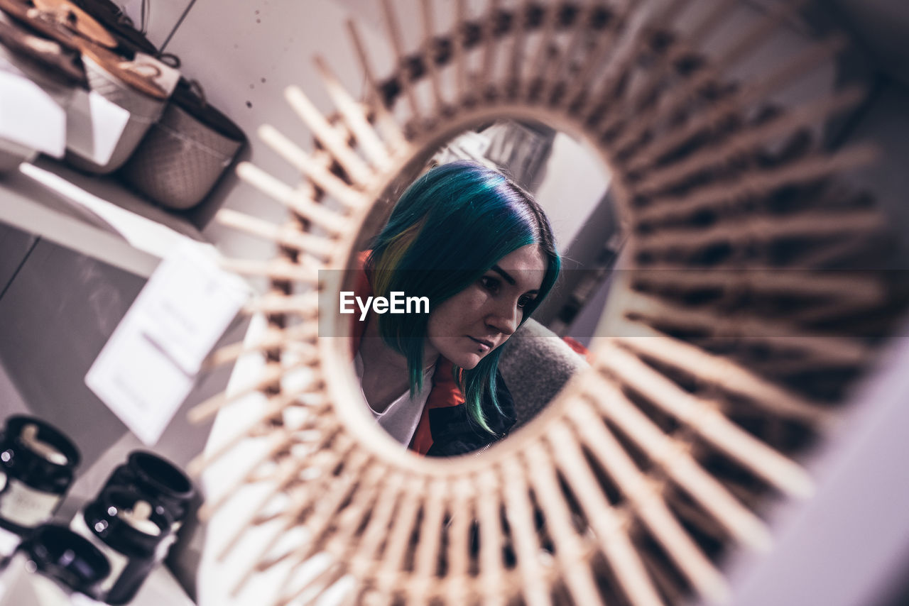 Close-up of thoughtful woman reflecting on mirror