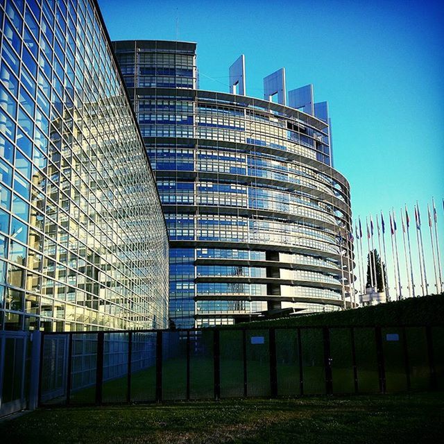 LOW ANGLE VIEW OF MODERN BUILDING AGAINST CLEAR BLUE SKY