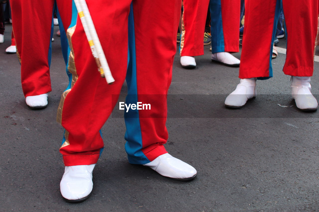 Low section of men in marching band on street