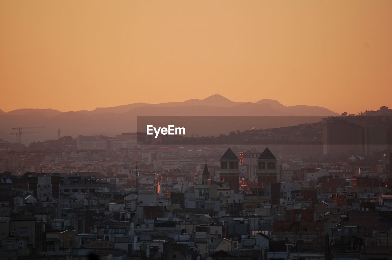 Cityscape against sky during sunset