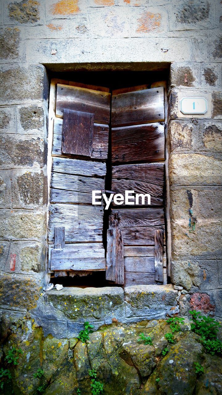 CLOSED WOODEN DOOR OF HOUSE