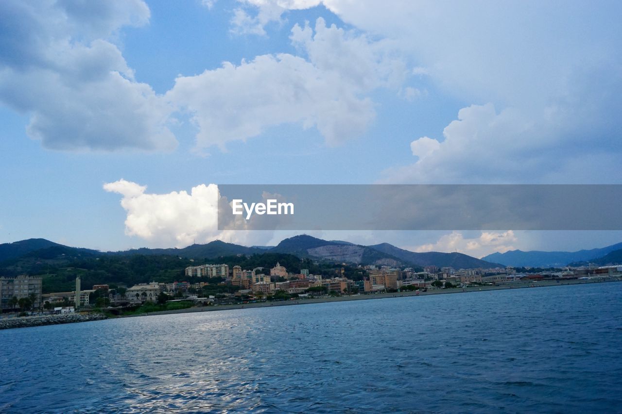 BUILDINGS BY SEA AGAINST SKY