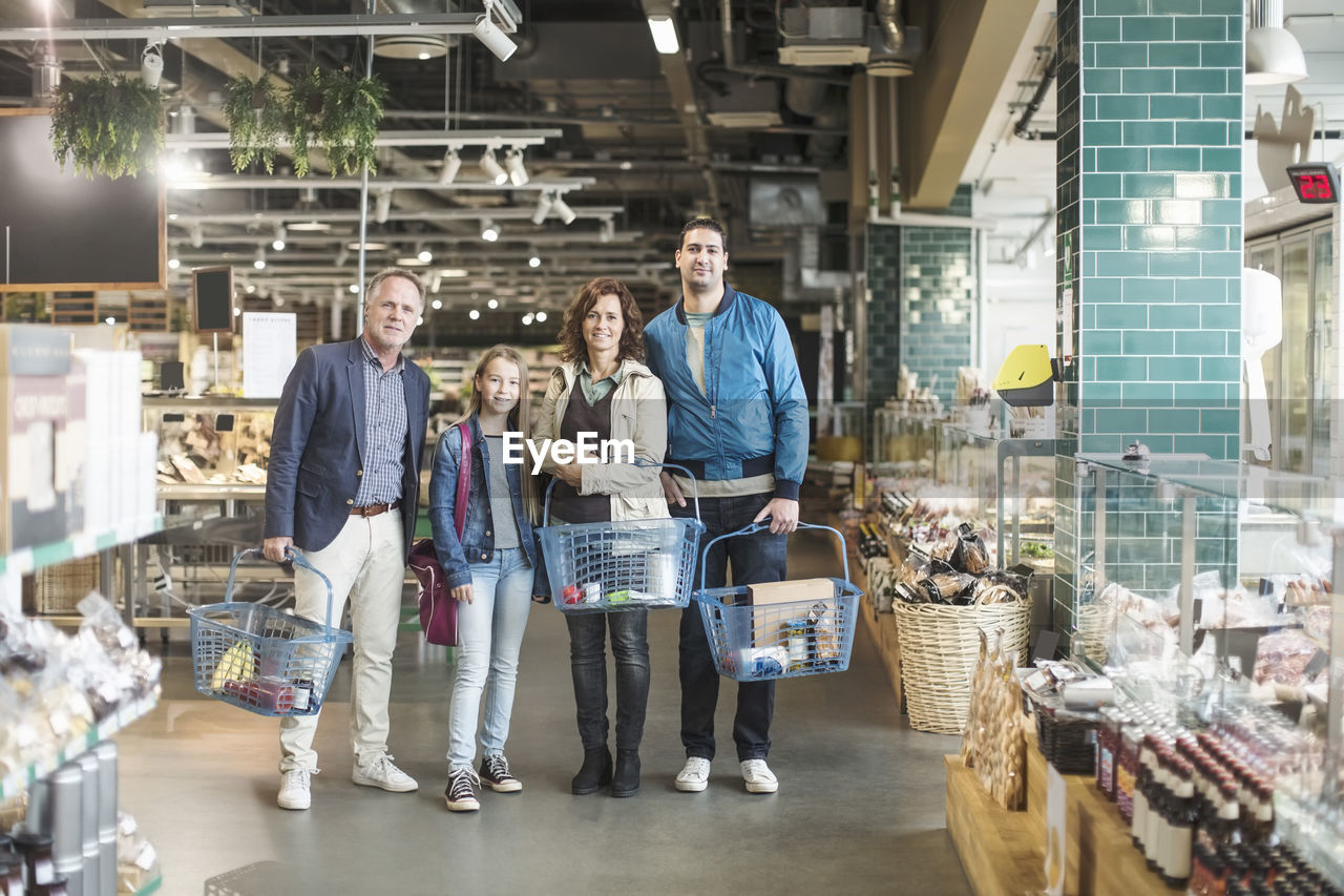 Portrait of family standing in organic food store