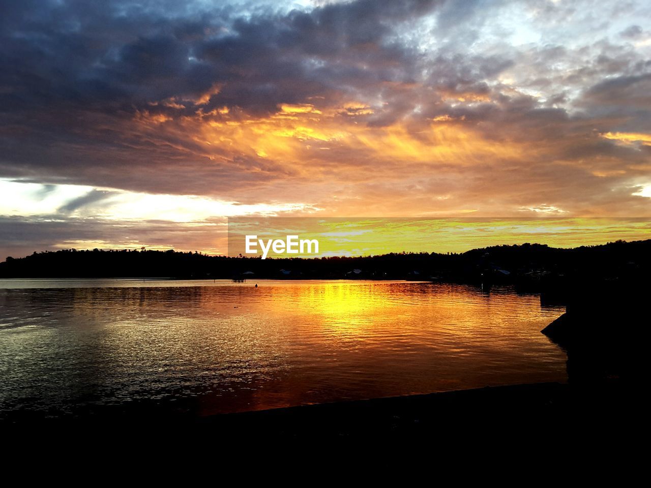 SUNSET OVER CALM LAKE