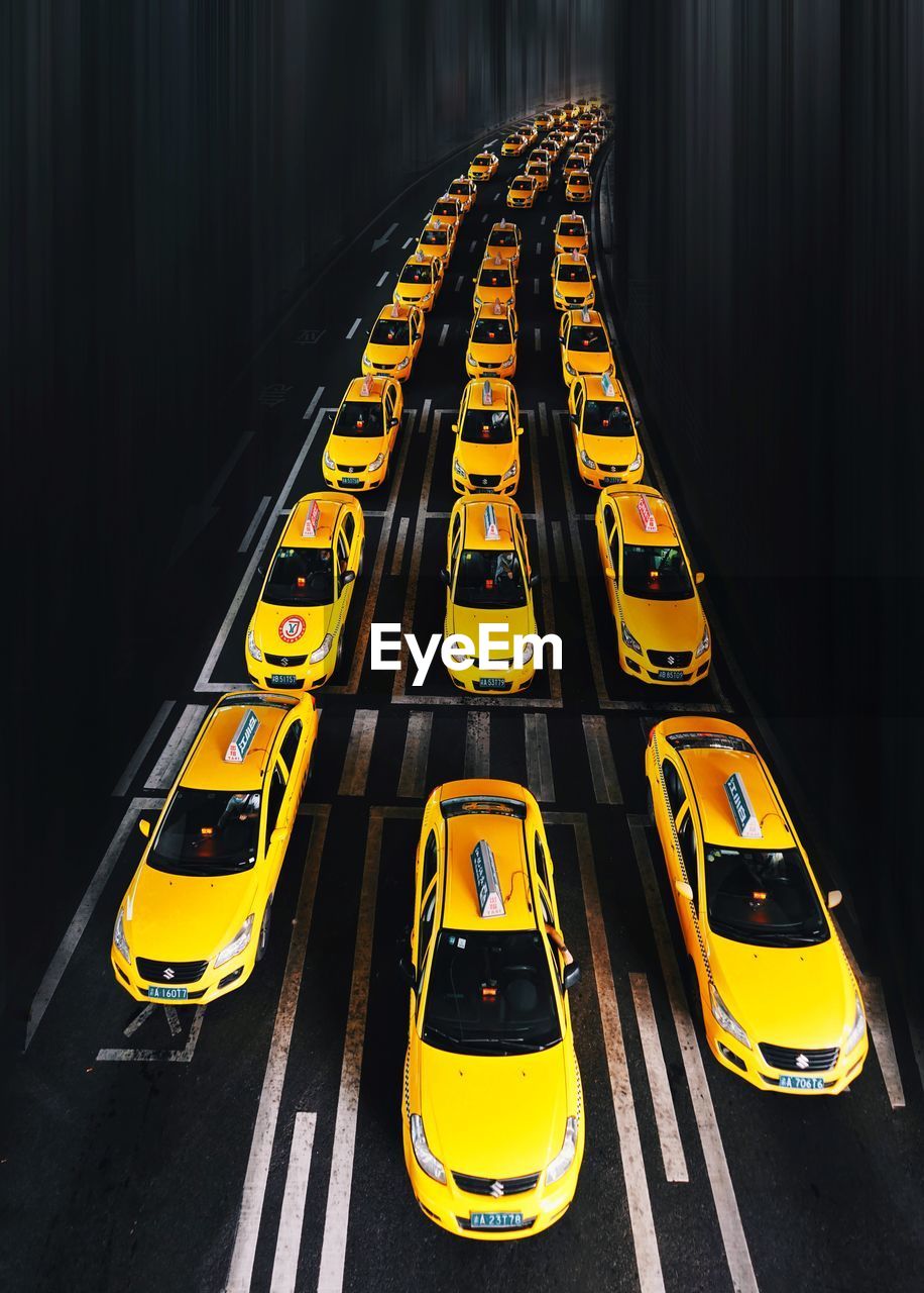 HIGH ANGLE VIEW OF YELLOW UMBRELLA ON STREET