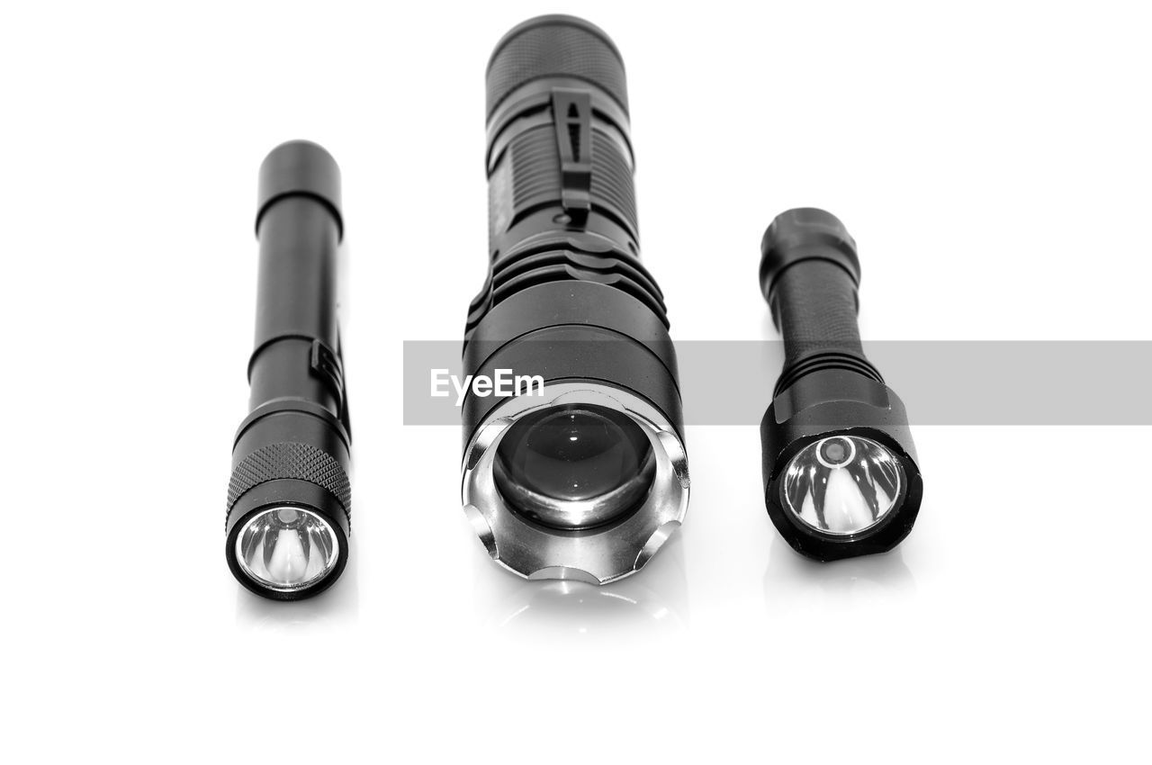 Close-up of flashlights on white background