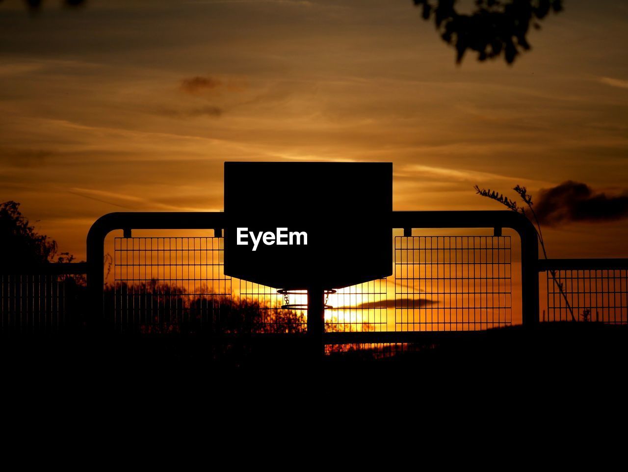 SILHOUETTE BASKETBALL HOOP AT SUNSET