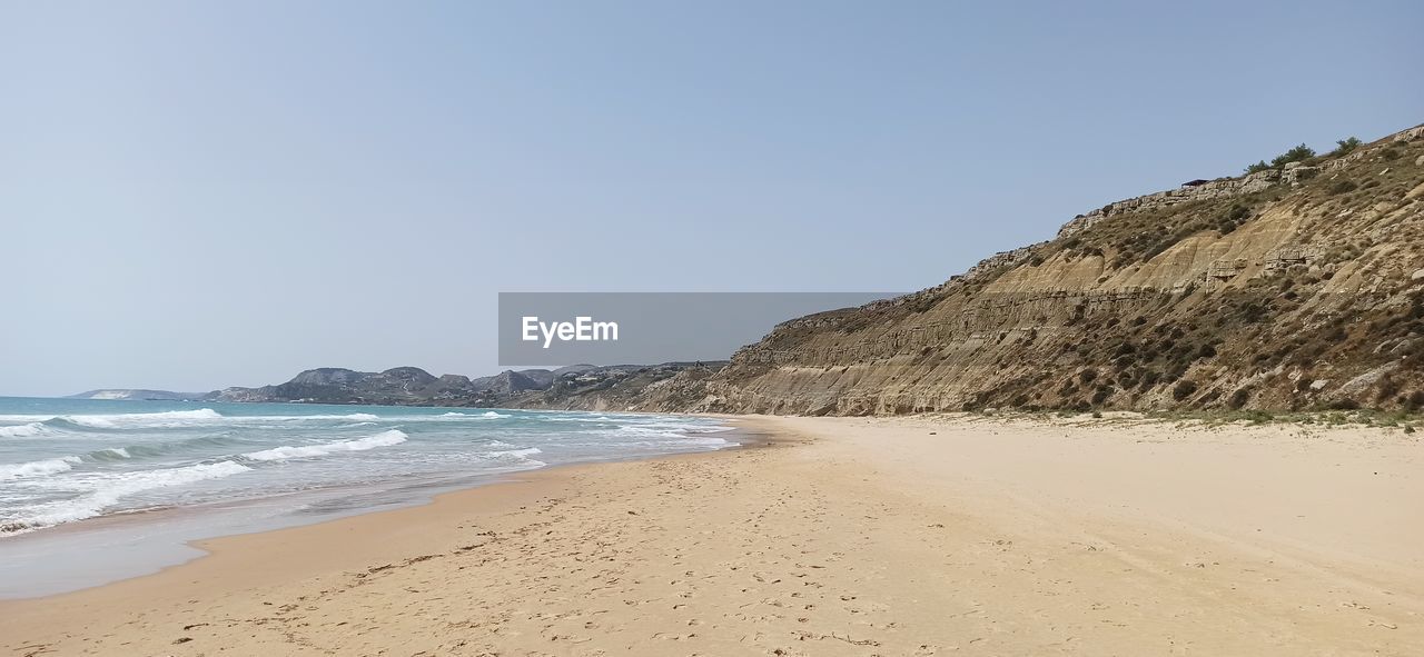 Scenic view of beach against clear sky