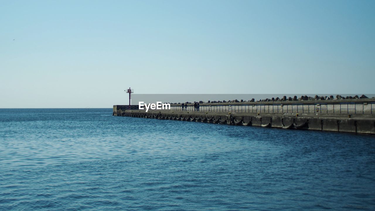 PIER OVER SEA AGAINST CLEAR BLUE SKY