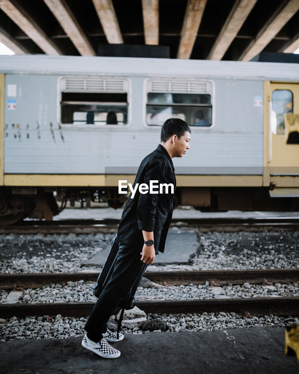 Side view of man in train at railroad station in yogyakarta jembatan janti