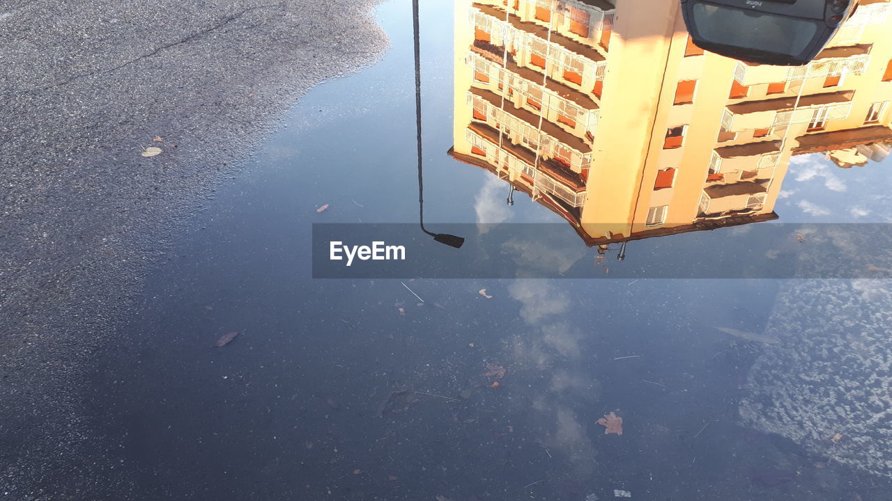 REFLECTION OF BUILDING IN PUDDLE