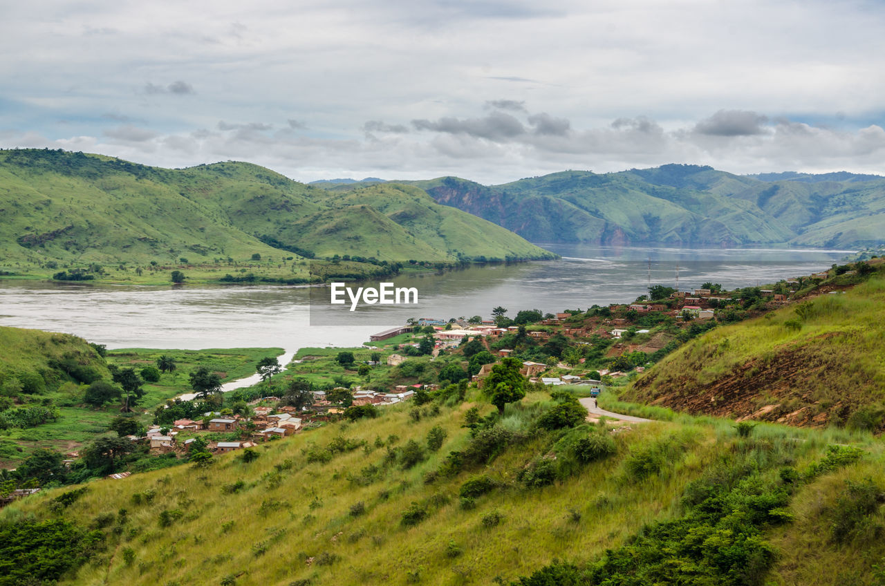 Scenic view of sea and mountains against sky