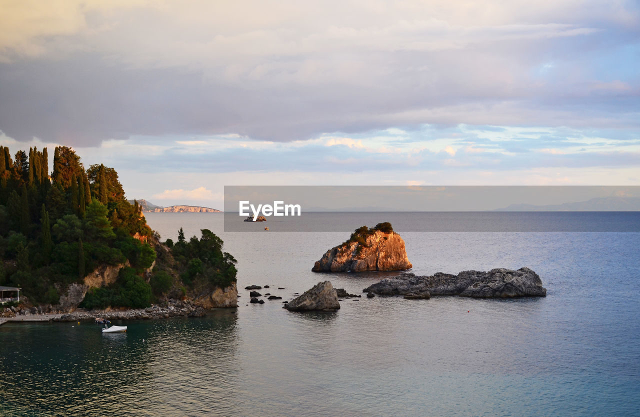 Scenic view of rock formation in sea against sky