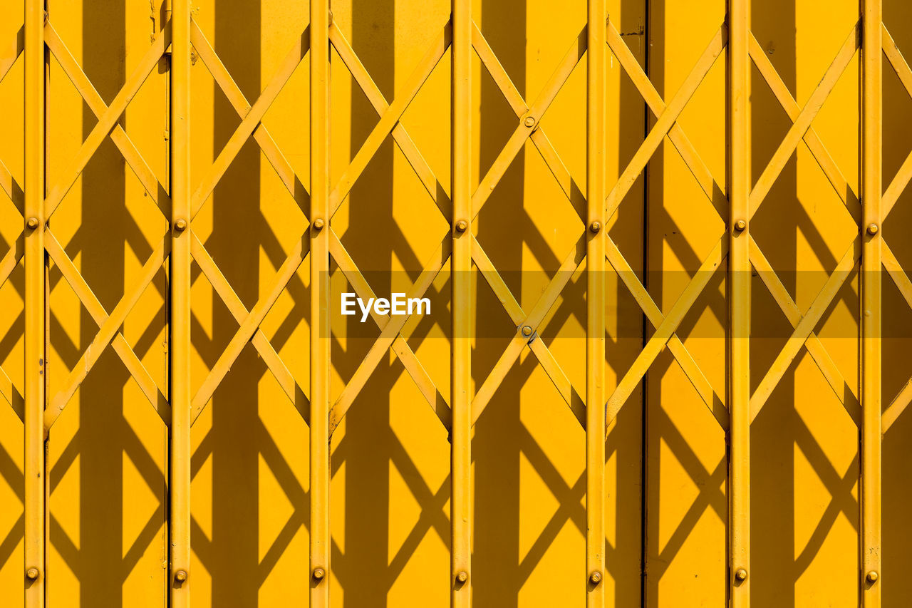 Full frame shot of yellow steel security fencing